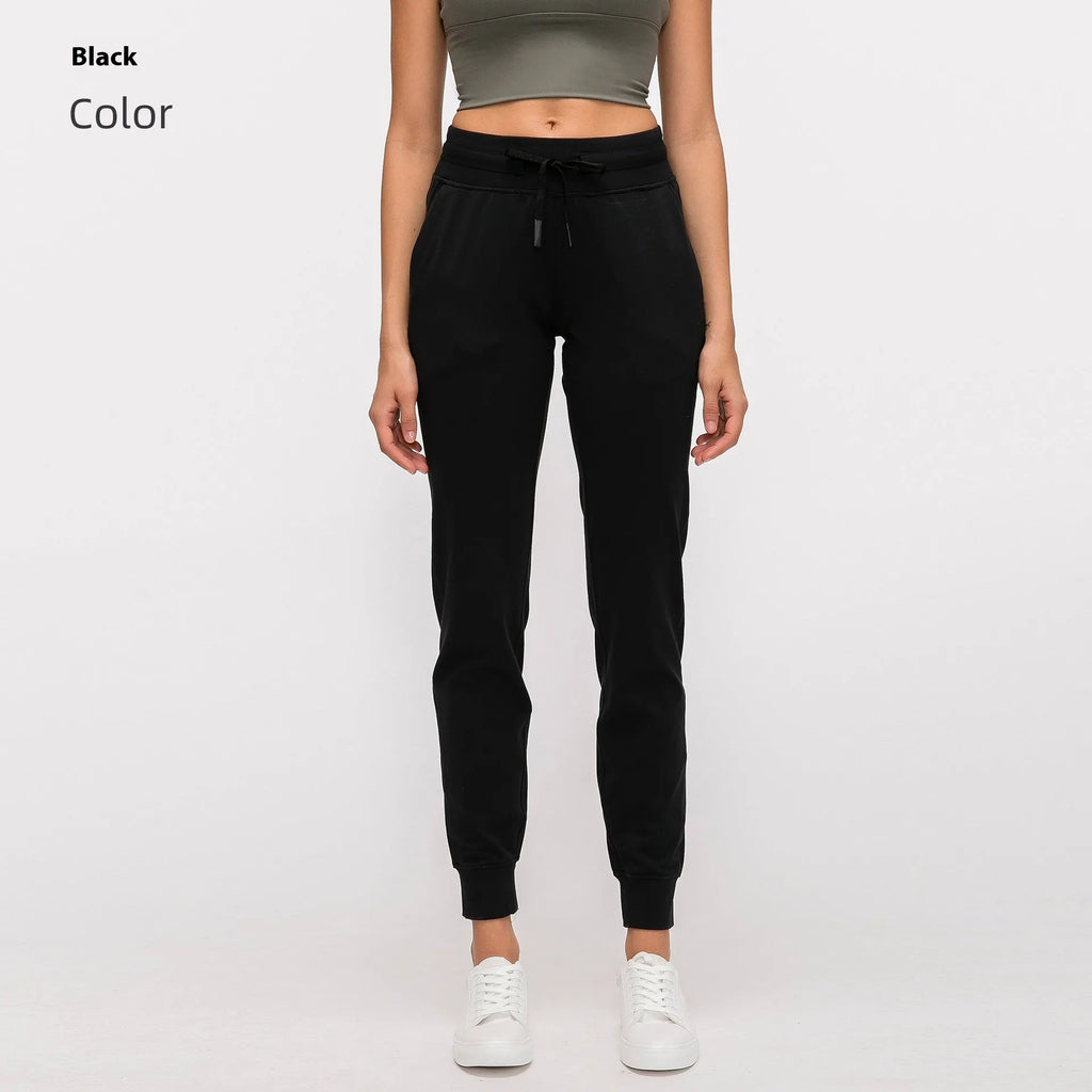 Women's high-waist yoga pants with a drawstring waist in a blue colour, laid flat.