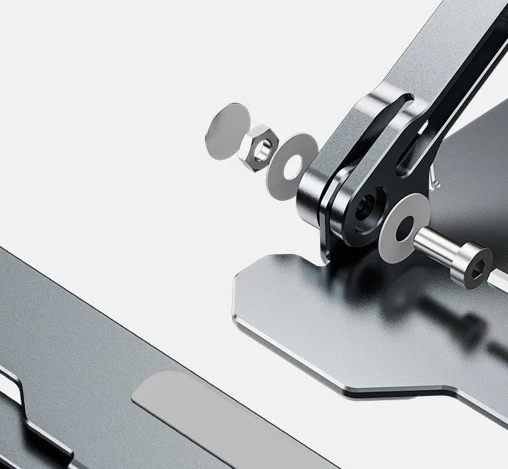 Grey aluminium laptop stand in a folded position next to an open laptop, showing its adjustable angle and hollow design.