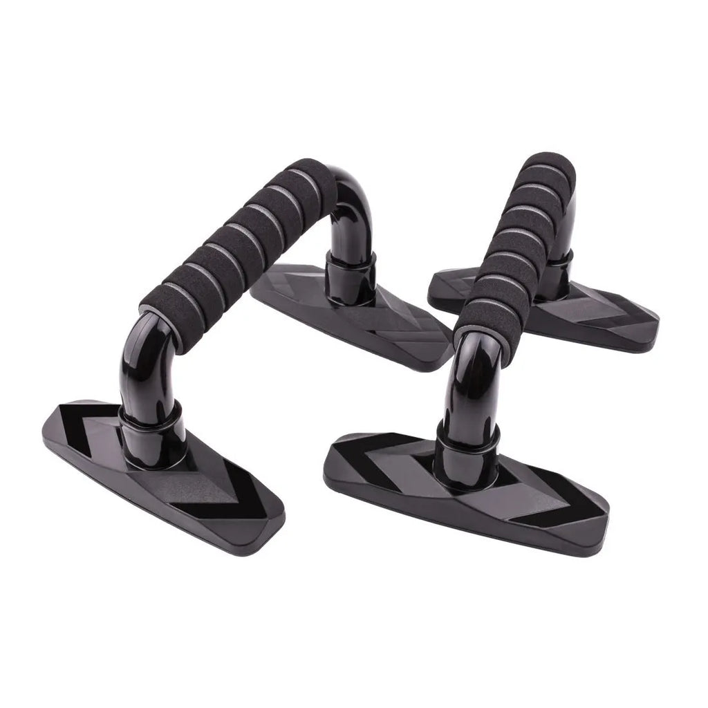 A pair of I-shaped black push up bars with textured PP sponge grip handles on a grey floor.