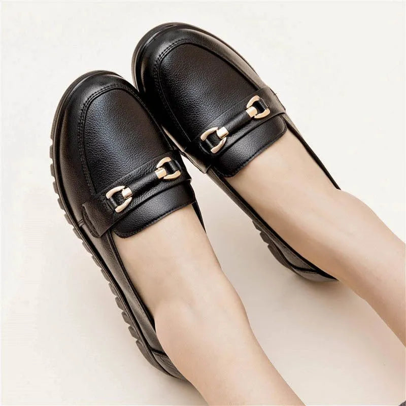 Black soft leather women's loafers with round toe and low flat heel on a rubber sole.