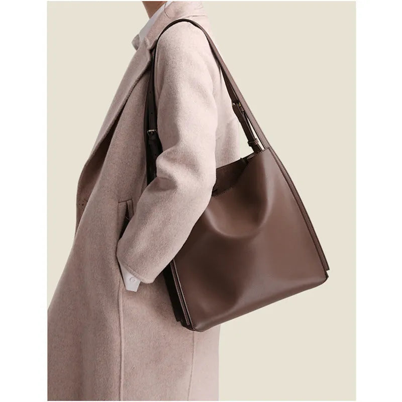 Brown genuine leather retro-style women's commuter bag with dual shoulder straps and external slit pocket.
