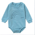 Baby wearing long sleeve waffle cotton romper with either cotton rope ties or button front closure in beige, khaki, green or blue
