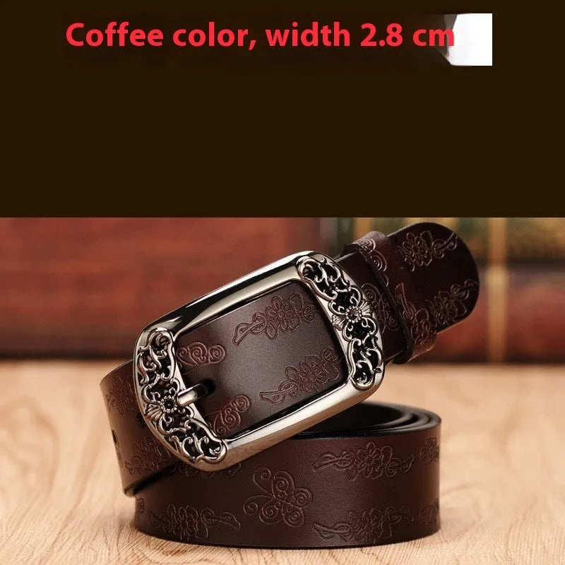 Thin black decorative jeans belt for women with an alloy buckle on a jeans waistband.