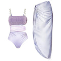 Purple women's one-piece swimsuit with a matching wrap skirt on a model, showing the quick-dry fabric and tight fit.