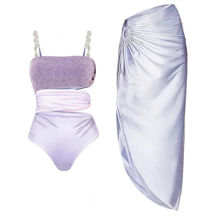 Purple women's one-piece swimsuit with a matching wrap skirt on a model, showing the quick-dry fabric and tight fit.