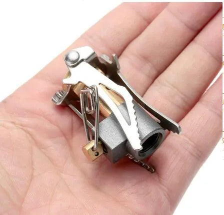 Portable folding mini camping stove in unfolded position showing 3000W burner and anti-skid bracket