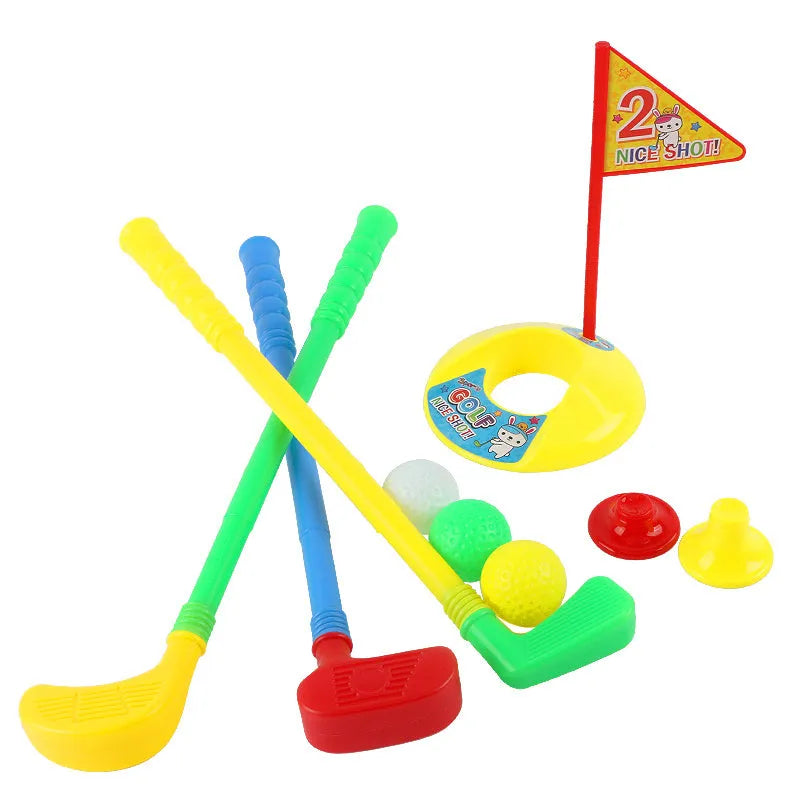 Children's golf set with three multicolour clubs, three balls, a hole, a flag, and two tees on a green background