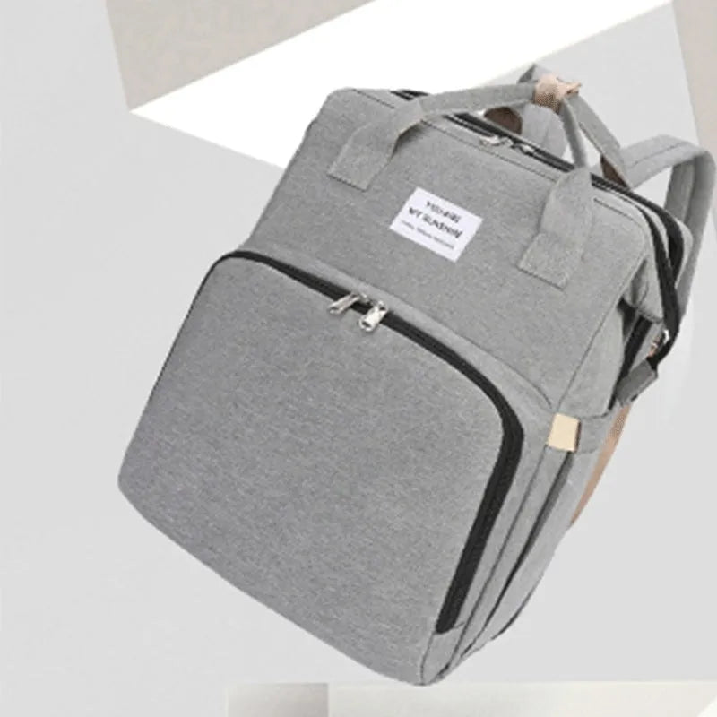 Lightweight nylon portable mummy bag with USB port and curved shoulder strap in various colours.