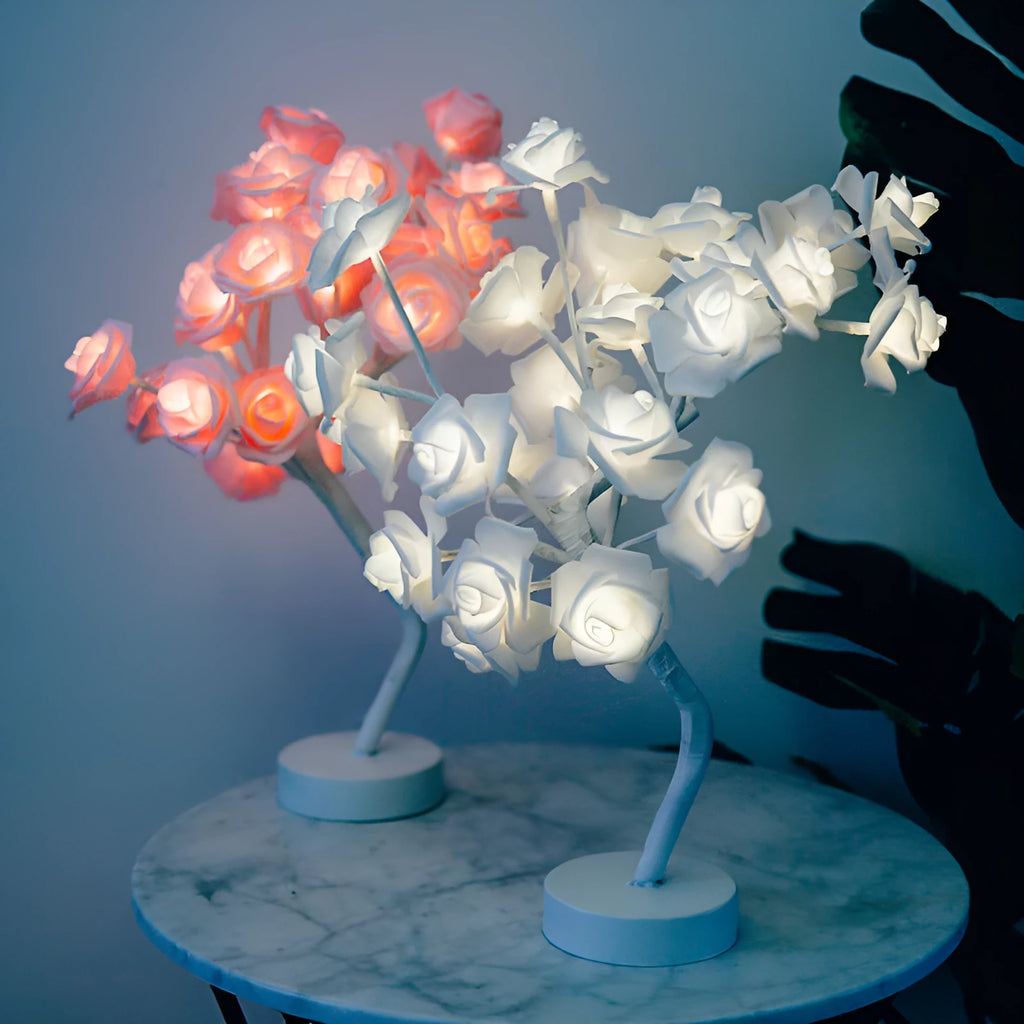 White and red rose flower LED table lamp with bonsai tree garland on a wooden table.