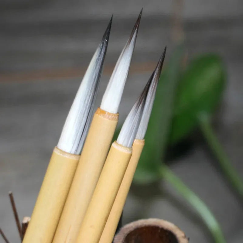 Set of four thin gold body wolf wool hook thread writing brushes for Chinese calligraphy.
