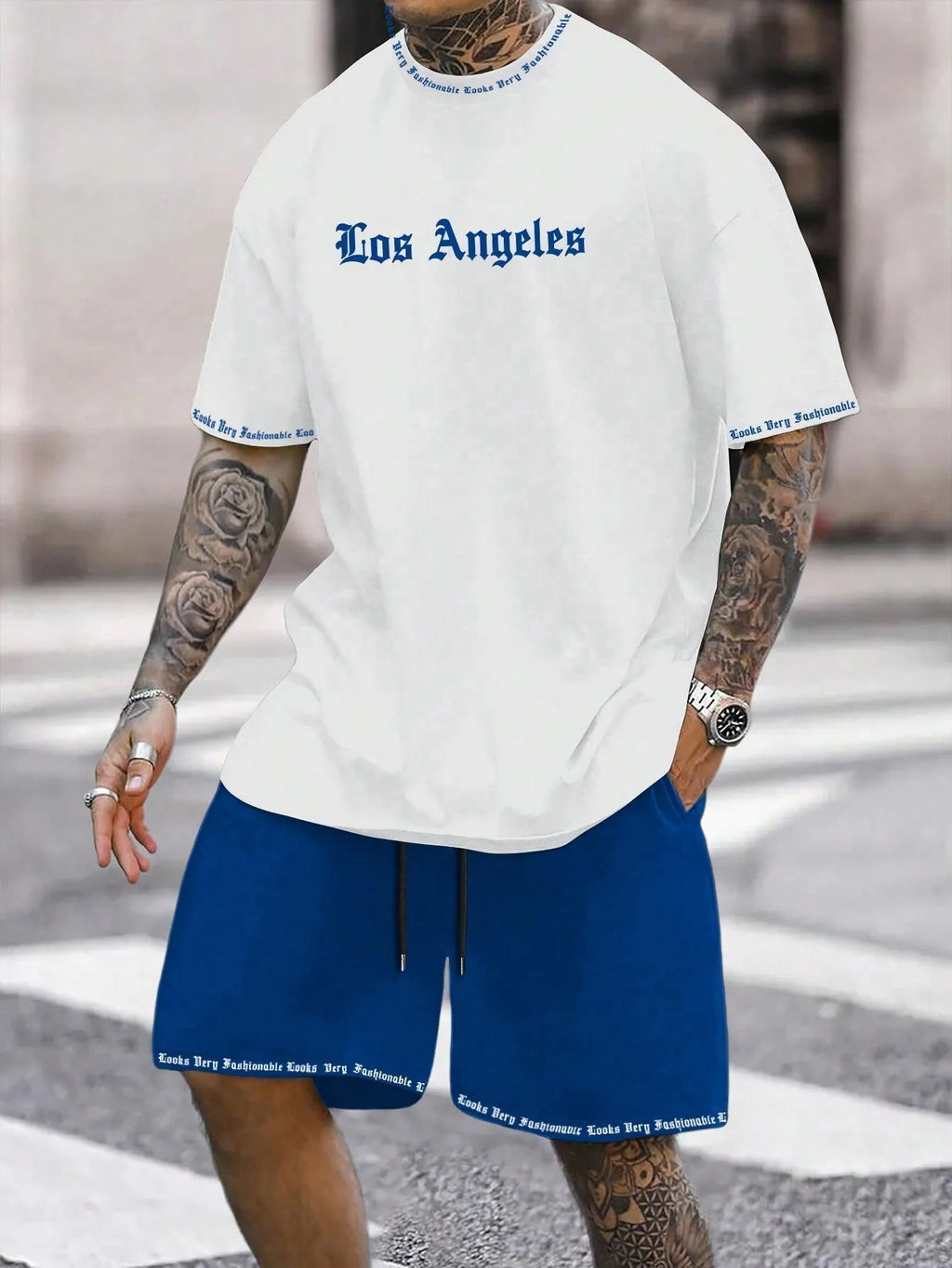 Man wearing a grey short-sleeved sports top and matching shorts from a quick-dry two-piece set.