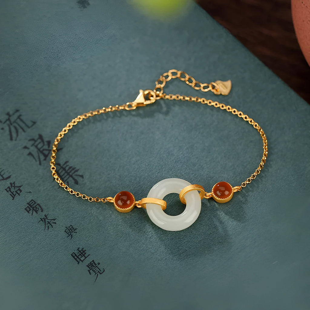 Gold-coloured women's bracelet made of S925 sterling silver with a natural Hetian jade peace buckle charm.
