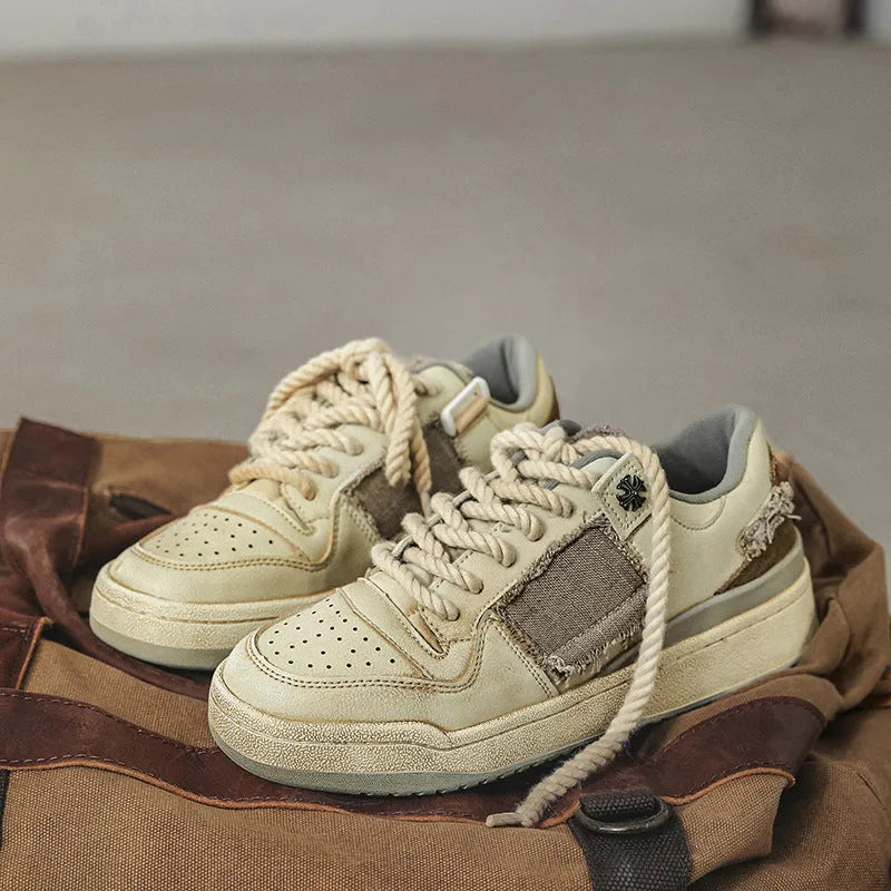 Beige low-top skateboard shoes with lace-up front and rubber soles