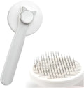 Blue self-cleaning cat and dog grooming brush with rubber handle and round-tipped pins