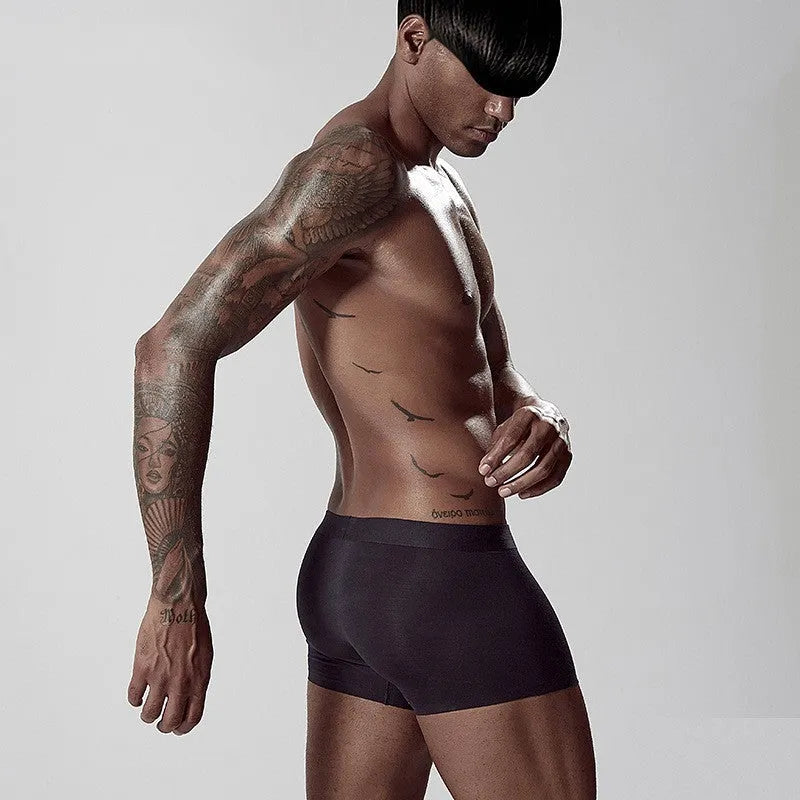 Men's seamless modal one-piece underwear in white, pink, or green with mid-waist hip lifting design