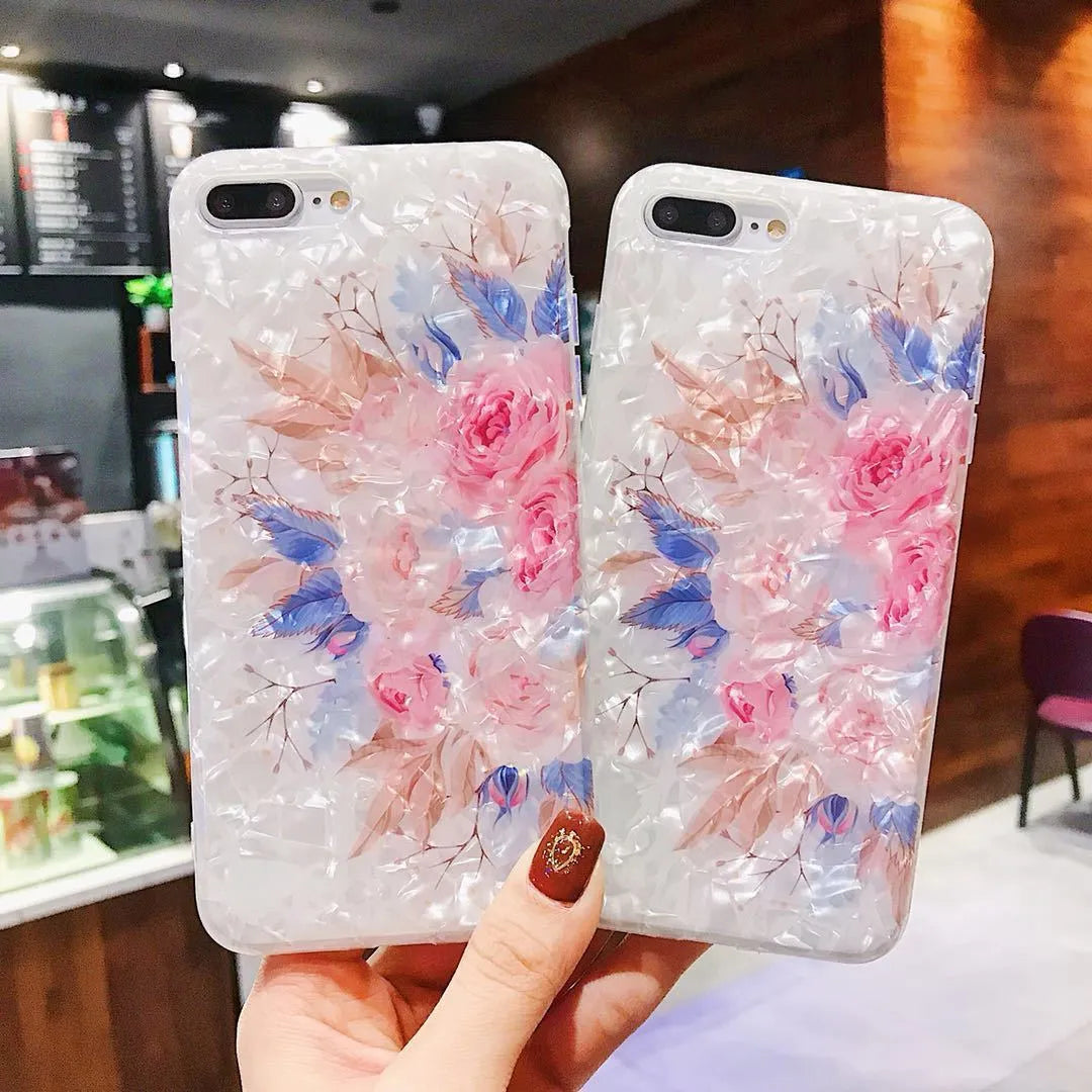 Soft TPU silicone iPhone case with a rose flower design on the back in brown, shown fitted to a phone.