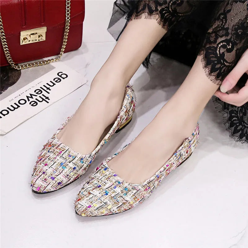 Women's black canvas casual flats with pointed toe and low-cut design on flat rubber sole
