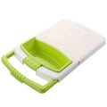Green multi-function cutting board with drain holes mounted on a kitchen sink edge