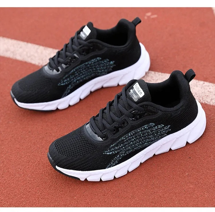 Women's black and white casual running sneakers with cross strap design and MD sole