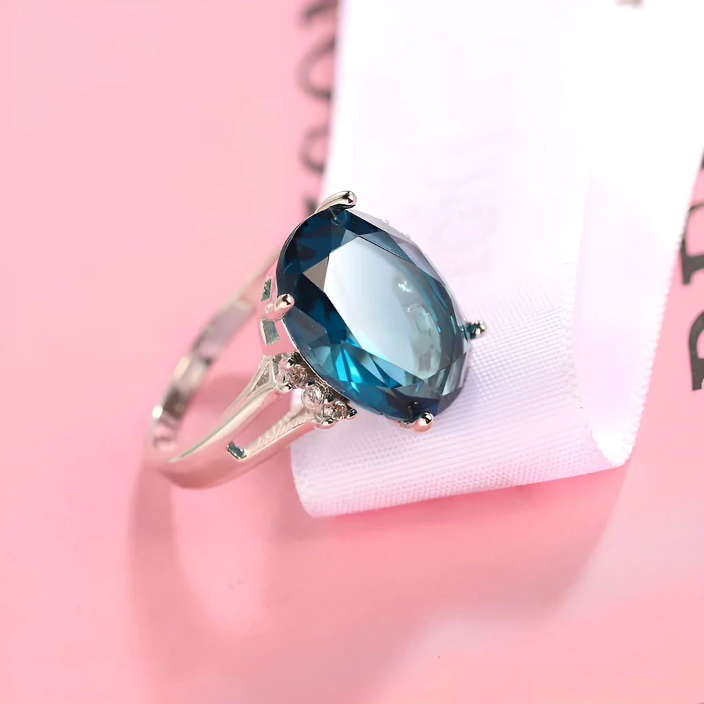 Geometric copper ring with a blue black elliptical zircon stone in a retro unisex style.