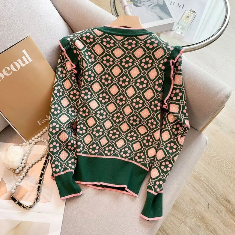 Green printed loose-fit sweater for women, shown on a hanger.