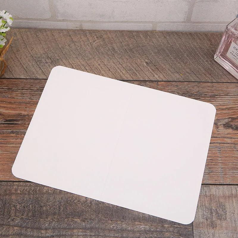 Pack of 100 blank folded kraft cards in 10x15cm size on a craft table
