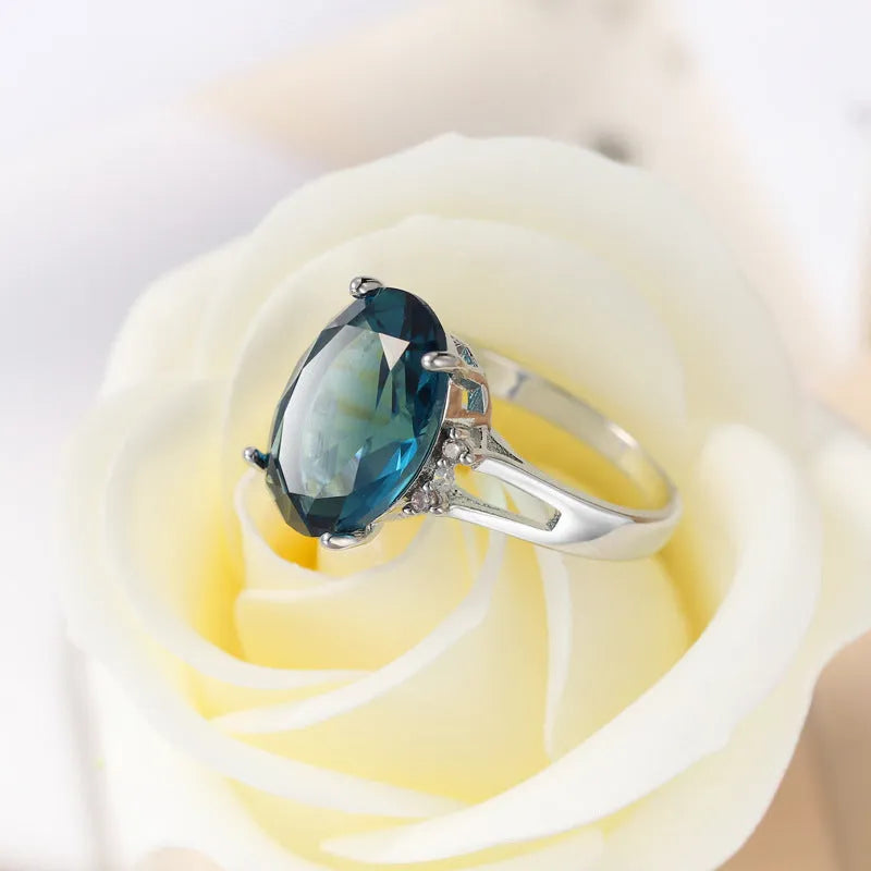 Geometric copper ring with a blue black elliptical zircon stone in a retro unisex style.