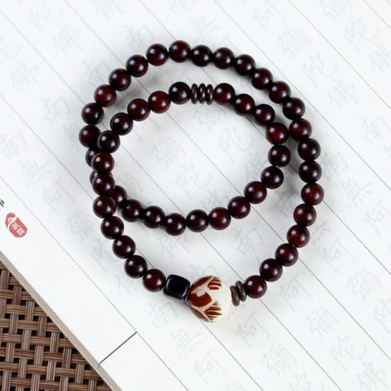 Rosewood bracelet with knitted construction showing floral carving details and 10mm diameter