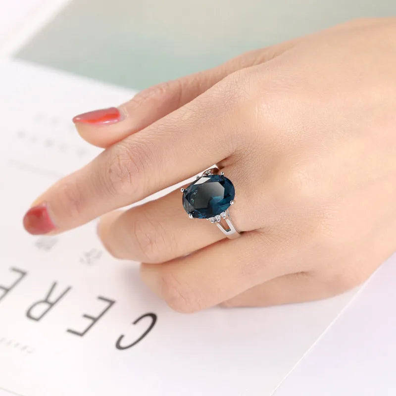 Geometric copper ring with a blue black elliptical zircon stone in a retro unisex style.