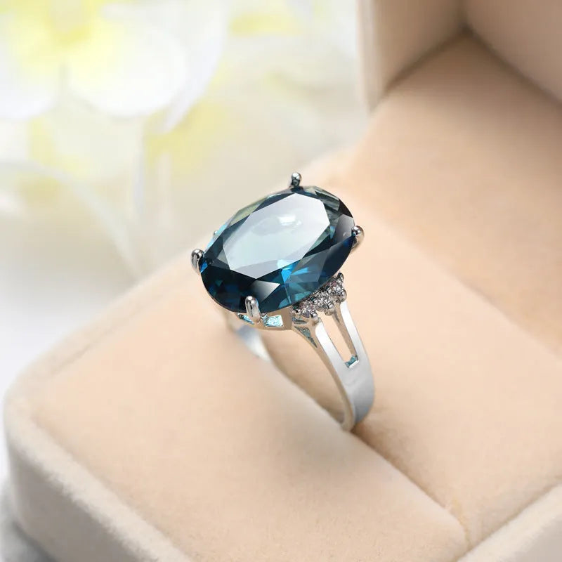 Geometric copper ring with a blue black elliptical zircon stone in a retro unisex style.