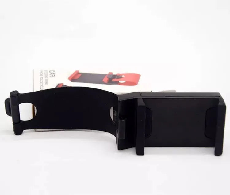 Black universal car steering wheel mobile phone holder made of ABS plastic shown mounted on a steering wheel.