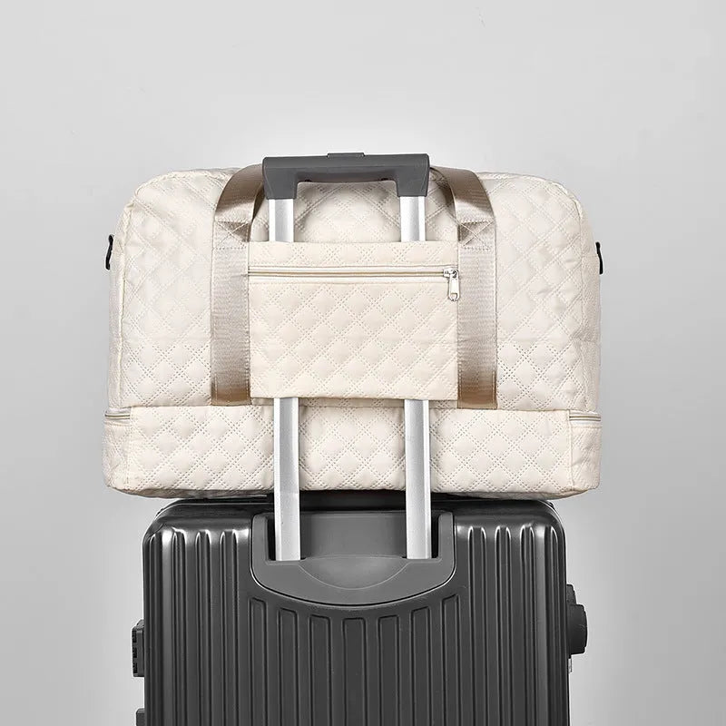 Large Oxford cloth travel bag in a solid colour with sewing thread details.