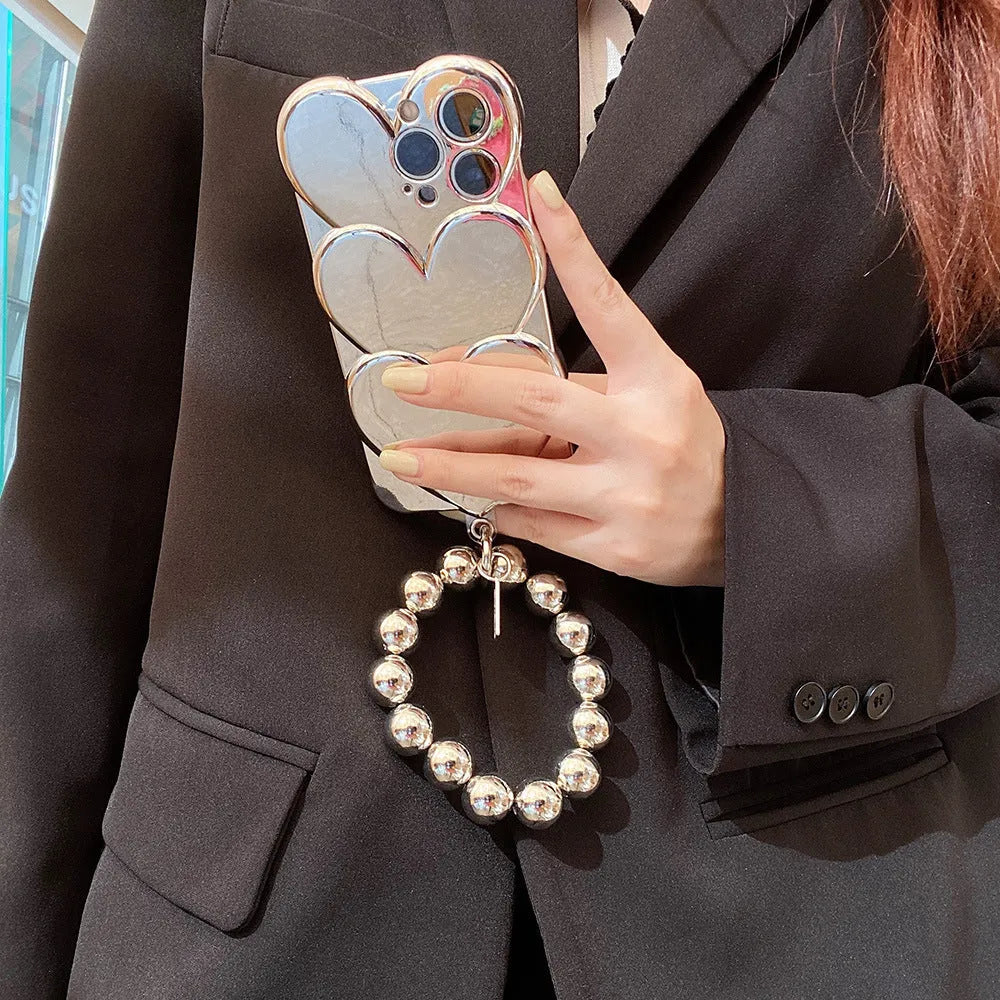 Flexible TPU iPhone case with a silver electroplated three-dimensional love design on the back.