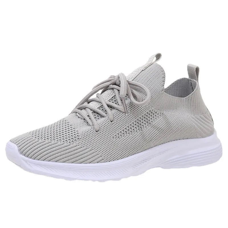 Women's low-top mesh running shoes in creamy white with a flat rubber sole and distinctive English muffin heel detail.