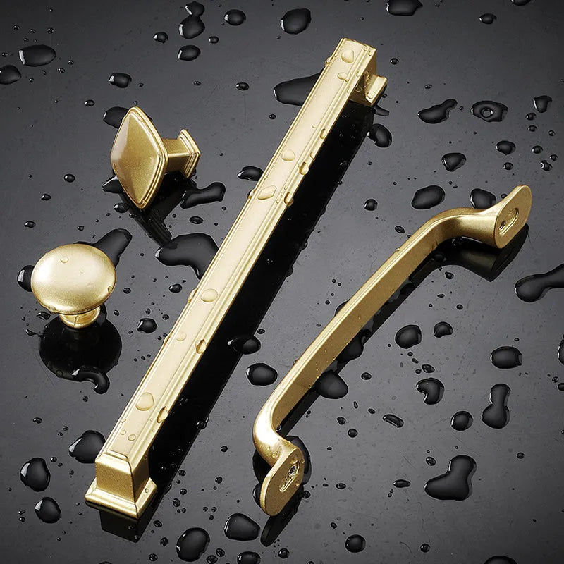 Gold aluminium alloy T-shape cabinet door handle with single-hole fitting.