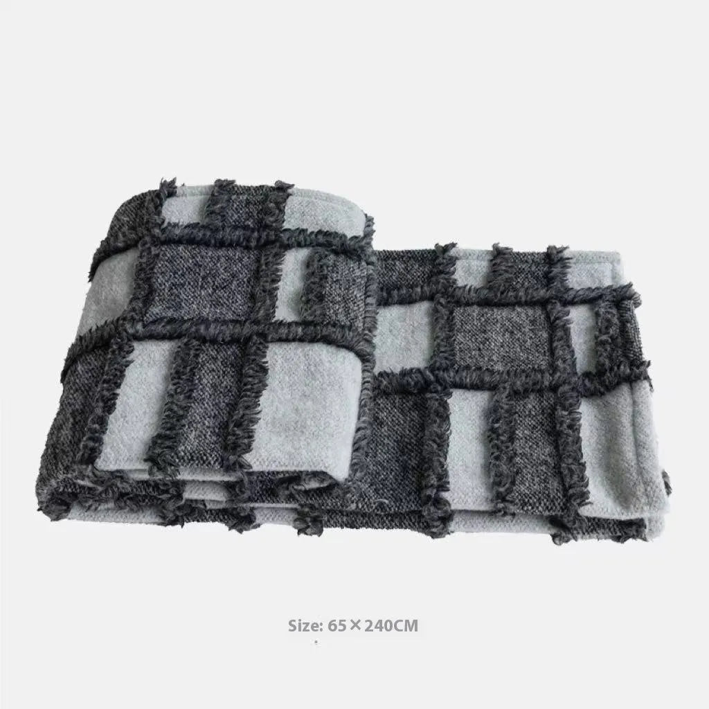 Modern grey and white plaid bed runner set with nap blanket and leather round pillow on a 1.8m bed.