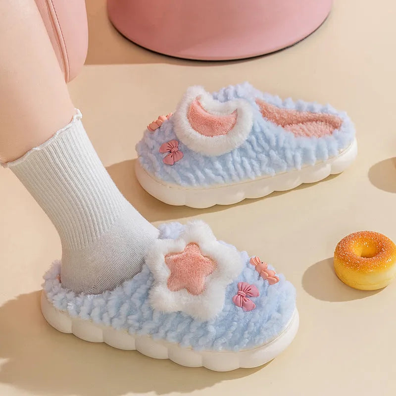 Women's light blue cartoon fleece-lined plush slippers with floral pattern and round toe.