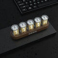 RGB Luminotron LED digital clock showing colourful display on desk