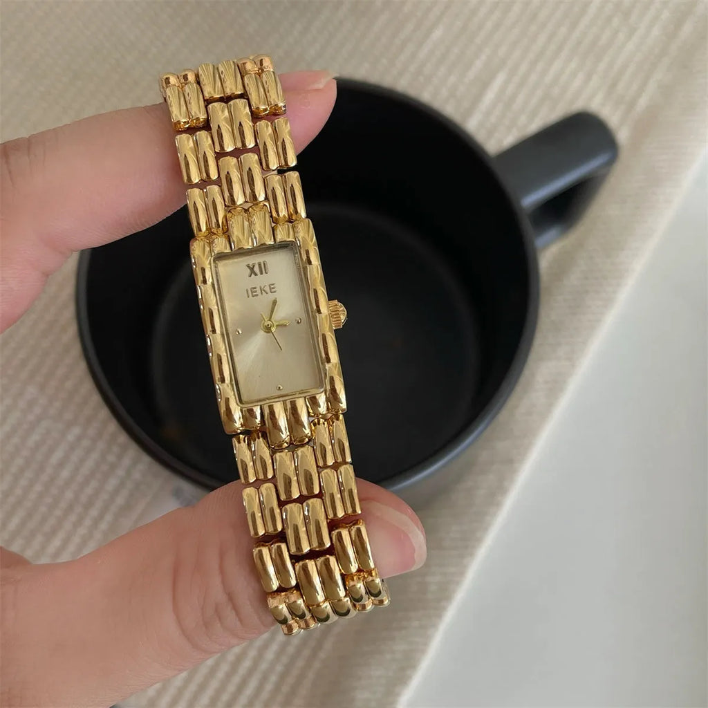 Mid-ancient style women's watch with butterfly buckle on wrist, showing gold and silver strap options