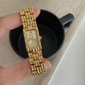 Mid-ancient style women's watch with butterfly buckle on wrist, showing gold and silver strap options