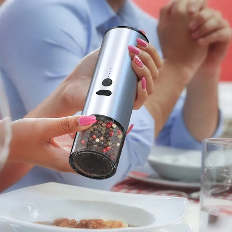 White and black electric salt and pepper grinders with USB charging ports and clear glass jars