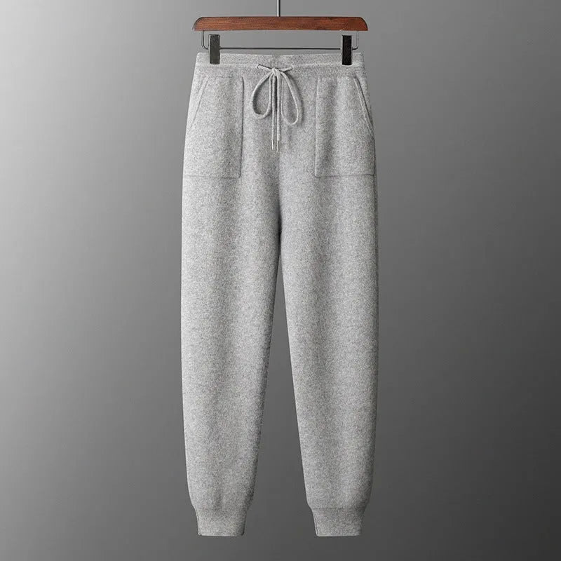 Men's light gray cashmere blend hoodie and matching long pants set on a hanger.