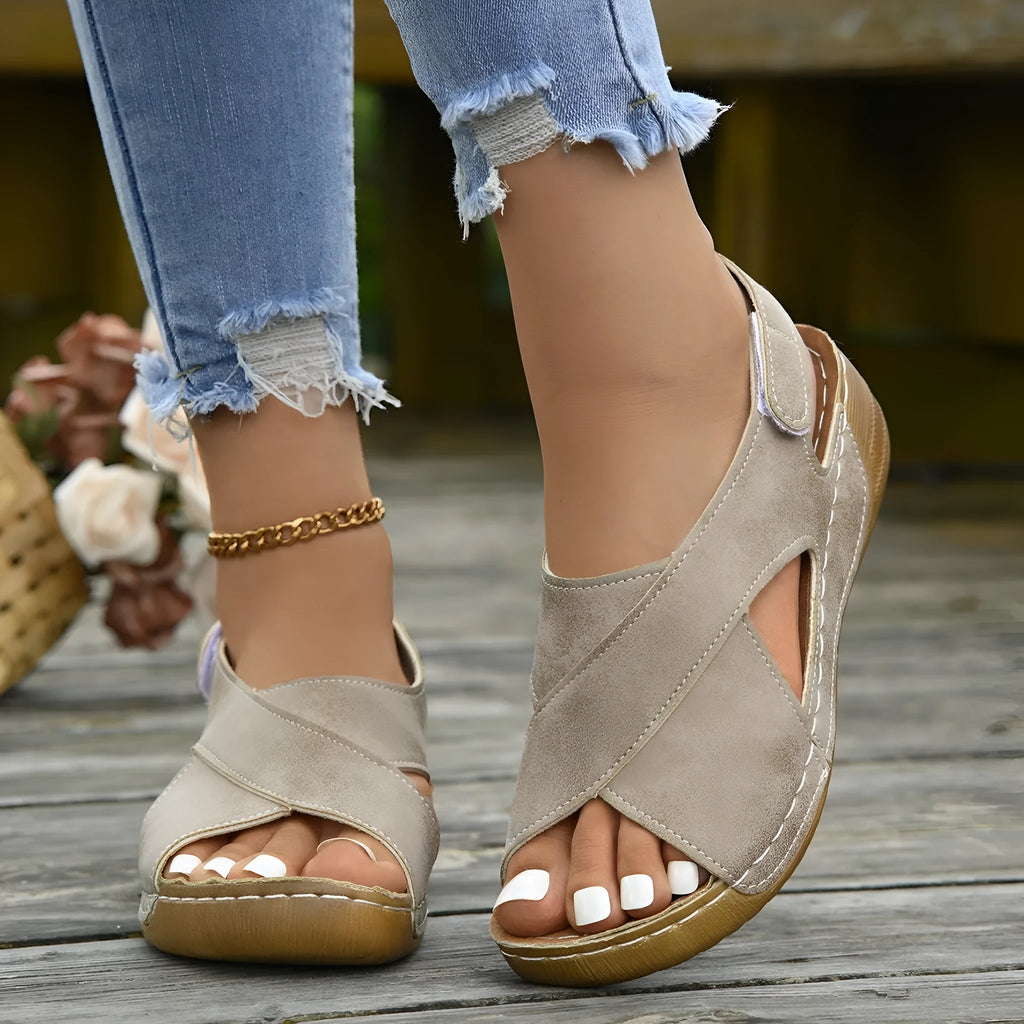 Women's brown roman platform sandals with a skirt detail and Velcro strap closure on a white background.