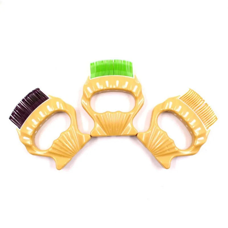 Shell-shaped plastic pet grooming comb with bent wire bristles in green, orange, or purple colours.