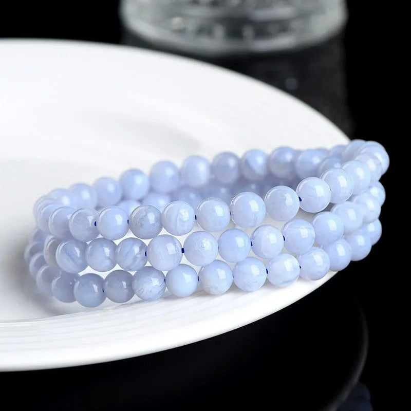 Blue agate beaded bracelet with Ruyi design elements and scattered striped beads