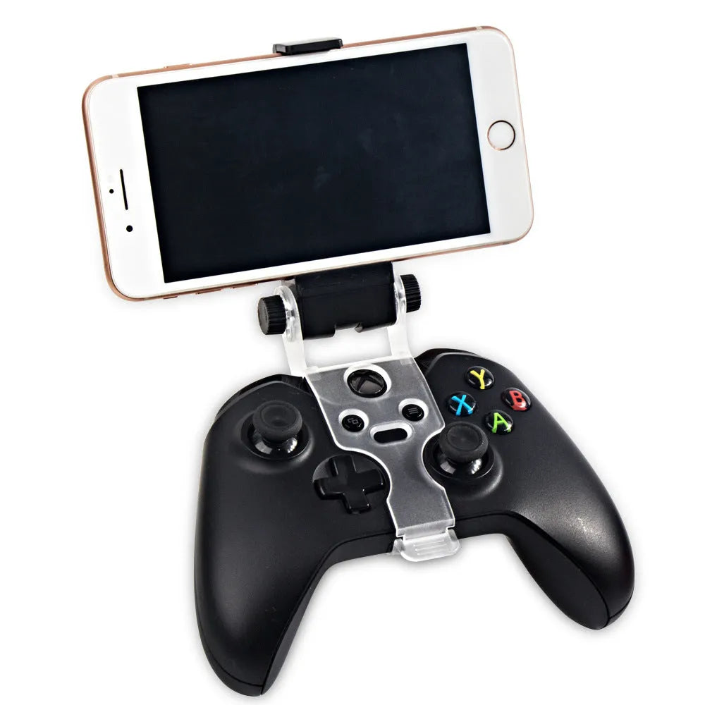 Black universal mobile phone holder clipped onto a car air vent, showing 360-degree rotation and clamp for smartphone