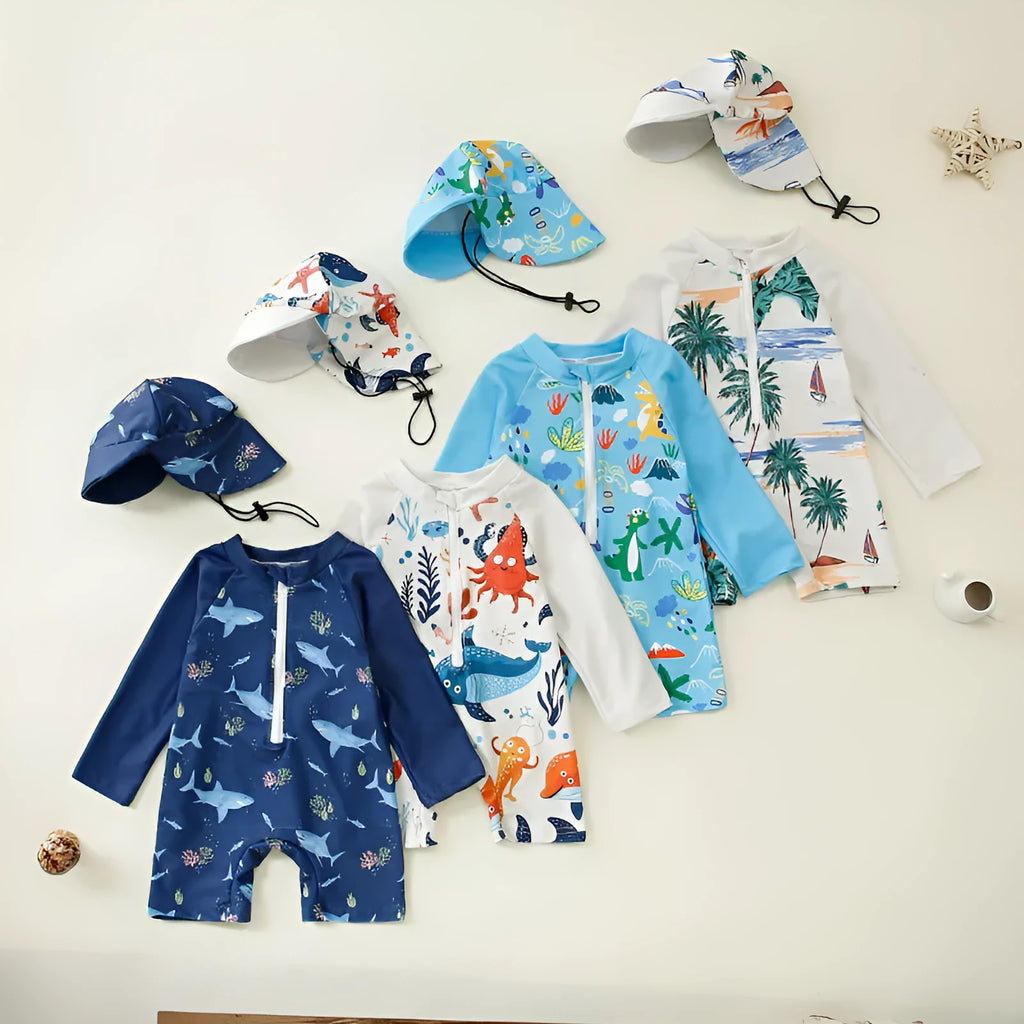 Children's one-piece jumpsuit swimsuit with matching hat in dark blue shark print, made from polyester