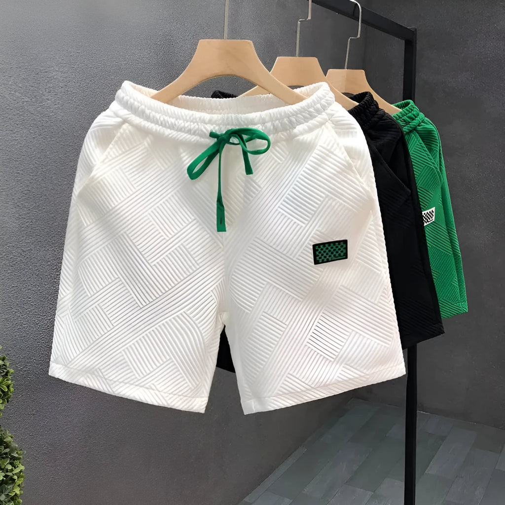 Casual polyester sports shorts in white, black and green colours with micro elasticity fabric