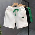 Casual polyester sports shorts in white, black and green colours with micro elasticity fabric