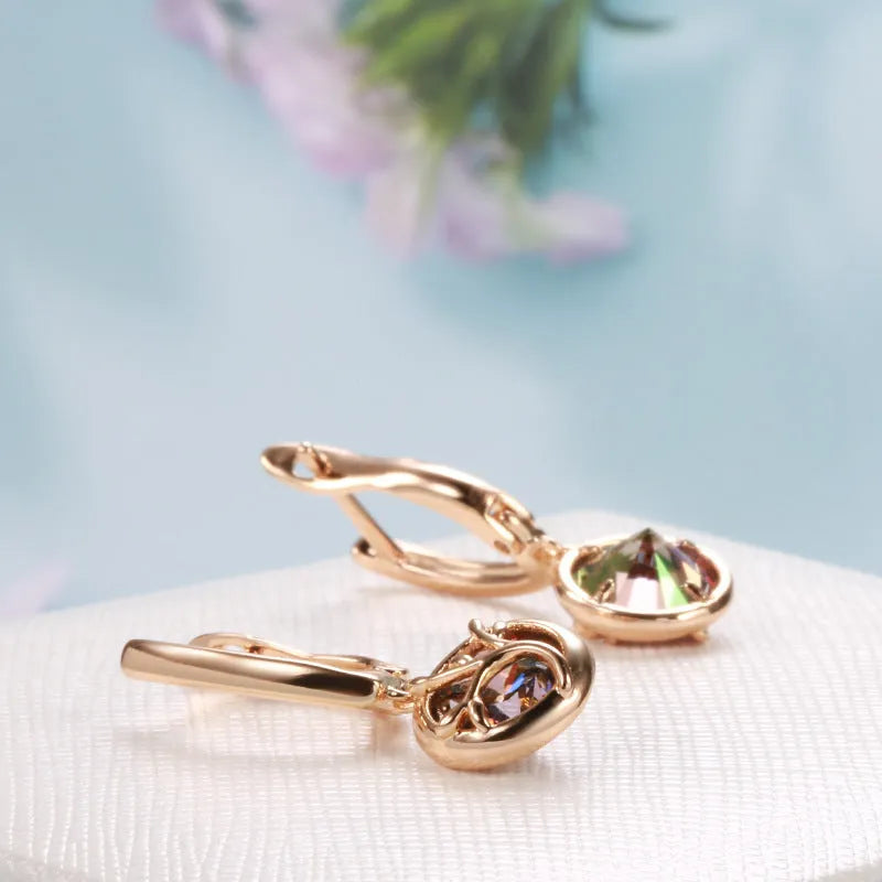 Rose gold plated copper drop earrings with artificial gemstone inlay on white background